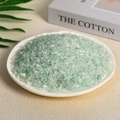 Natural green aventurine crystal chips in a light colored tray for aromatherapy - 100 Grams Of Green Fluorite (3-5mm)