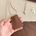 Detail of brown faux leather key case necklace featuring white contrast stitching - Brown Key Case