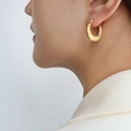 French style gold-plated titanium steel textured hoop earrings shown on a model - Gold Croissant Texture Earrings (F478)
