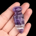 Handheld view of a carved natural purple amethyst dagger model with white veins - Amethyst
