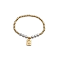 Detailed macro of gold beaded bracelet with pearls and square pendant engraved with letter C - Letter C