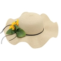 Detailed view of women's straw sun hat with large wavy brim and yellow flower accent - Beige