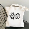 White canvas tote bag featuring a vintage black sun and moon print on a black mesh chair - STD438-O (Black Retro Mystic Sun Moon Totem)