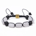 Detail of hand-woven bracelet with lava stones, white beads, and gold Tree of Life charm - White Stone Bracelet