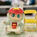 Dimoo McDonald's series plush doll wearing red visor and apron in green color variant - Pendant Apron M Mcdonald's / First And Second Generation Keychains Are Compatible With La Cloth Dolls. Dolls Not Included.