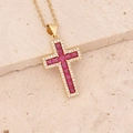 Detailed view of a gold cross pendant with red square gems and micro-set clear zircons - Red