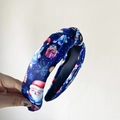 Blue Christmas headband with Santa and snowflake prints featuring a chic top knot design - Blue Floral Print