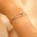 Detail of silver paperclip style bracelet on wrist with a minimalist fashion aesthetic - White K Pin Bracelet (DZ-350)