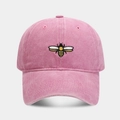 Close-up of pink bee embroidery on a vintage washed cotton baseball dad hat - Pink
