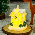 Luminous resin Christmas cottage with warm LED light and artificial snow details - Style F Gift House