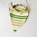 Detail view of a floral green and orange satin headscarf with elastic band on white background - Satin Green Orange Floral