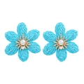 Detailed view of sky blue woven raffia flower earrings with pearls and crystals - Blue