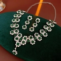 Makro-Detail von Sonnenblumen-Anhänger-Halskette und Ohrringen mit grünen Steinen und Kristallen - Schmuckset mit grünen Edelsteinen und Strasssteinen