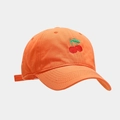 Detailed view of cherry embroidery and stitching on a vibrant orange cotton baseball cap - M (56-58cm) / Orange