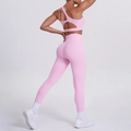 Detail of light pink one-shoulder yoga bra and high-waist seamless leggings on model - Sakura Pink