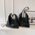 Macro shot showing small and large black leather hobo tote bags with premium texture - Small / Black