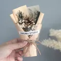 Detailed view of mini dried flower bouquet with pine cones and baby's breath wrapping - Pine Cone Gypsophila (Apricot Wrapping)