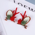 Detailed close-up of Christmas reindeer antler hair clips with red horns and bells - Teddy Red Green Ball Red