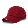 Detailed close-up of distressed ripped details on a vintage burgundy cotton baseball cap - Burgundy