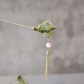 Detailed macro view of a bamboo style green hair stick with pink beads and golden tassels - F0714-Enamel Bamboo