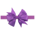 Detail of purple grosgrain ribbon bow on elastic baby headband against white background - Deep Purple