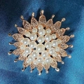 Golden camellia brooch with white pearls and sunburst design on dark blue silk background - Pearl Epiphyllum Brooch