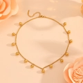 Detail of gold necklace featuring small steel bead pendants and lobster clasp closure - Gold Ball Pendant Necklace