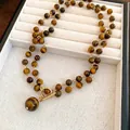 Tiger eye stone beaded necklace with golden toggle clasp and round pendant - Necklace-Coffee