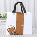 Cute cartoon bear non-woven tote bag with brown patchwork and reinforced black handles - Milk Tea Bear