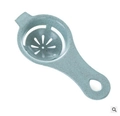 Blue egg white separator tool with speckled texture for kitchen use on white background - Wheat Green