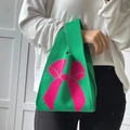 Green knit tote bag featuring a large pink bow pattern and ribbed vertical texture - Grass Green Bow