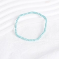 Close-up of a sky blue bohemian beaded bracelet on a wavy white textured background - Sky Blue