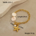 Macro shot of gold ocean bracelet with natural shells, starfish charm and small pearl - Round Shell Bracelet