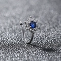 Macro shot of silver non-piercing clip jewelry with blue gemstone and clear zircon stars - Snowflake Blue Gem (SE1583)