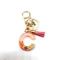 Detalle de llavero letra C de resina rosa con purpurina dorada, abeja y borla rosa - Letra C Llavero Abeja