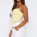 Pale yellow y2k camisole top with ruffles and corset styling shown from a side view - S / Yellow
