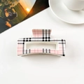 Detail of pink plaid square hair claw clip with cutout design on white background - Cream White Burberry Style Checkered