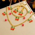 Close-up of gold stainless steel jewelry set with red enamel cherry pendants and beads - Red Cherry Enamel 3-Piece Set (N3122 B1512 E6176)