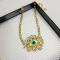 Macro detail of gold evil eye pendant with turquoise stones and hanging pearl - Blue Eye Necklace Z-2074
