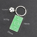 Metal soccer keychain with green field pendant and black and white football charm - Soccer Field