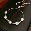 Macro detail of silver halo bracelet with five oval zircons and adjustable slider clasp - Silver-White