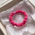 Detail view of a rose red velvet scrunchie showing soft chenille texture in a gift box - Rose Red