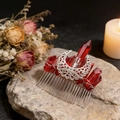 Detail view of handmade moon hair comb with raw red crystals on vintage dark floral background - Deep Red Crystal + Hollow Moon
