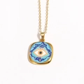 Detailed view of vintage gold evil eye pendant with blue and orange enamel drip oil art - Classic Blue White Evil Eye (Style 10)