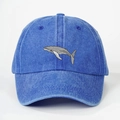 Close-up detail of grey whale embroidery on a dark blue washed denim baseball cap - Royal Blue