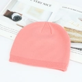 Pink knitted beanie hat in ribbed cuffed style for winter warmth on lifestyle background - Pink