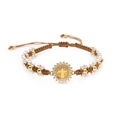 Macro detail of hand-woven bracelet with Saint Benedict medal and sparkling crystals - Adjustable / Brown