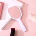 Minimalist white handheld makeup mirror with sleek handle for portable daily cosmetic use - White