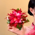 Close-up view showing the realistic texture and vibrant colors of the red fabric flower hair clip - Duckbill Hair Clips / Red/Green