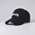 Close-up of TALES towel embroidery and fine stitching on a black cotton baseball cap - Black